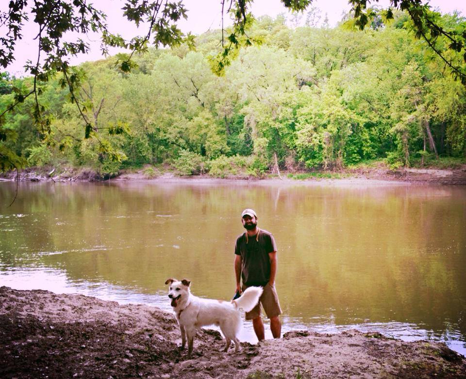 A
                    person and dog in a desert Description automatically
                    generated